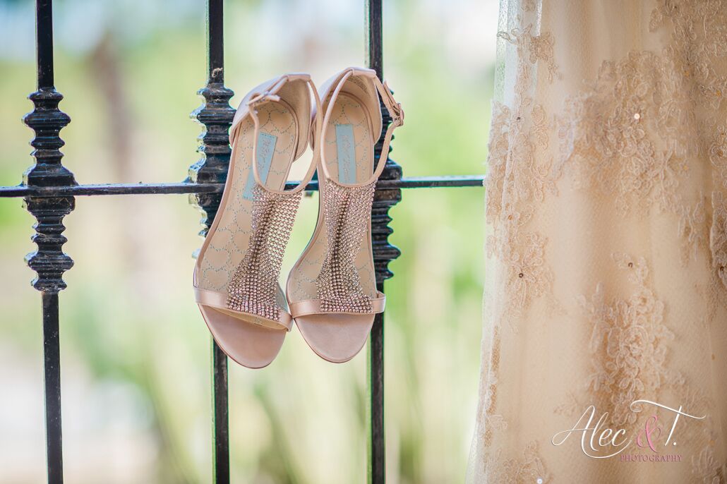 wedding dress taken in Los cabos Mexico with gold shoes on railing 