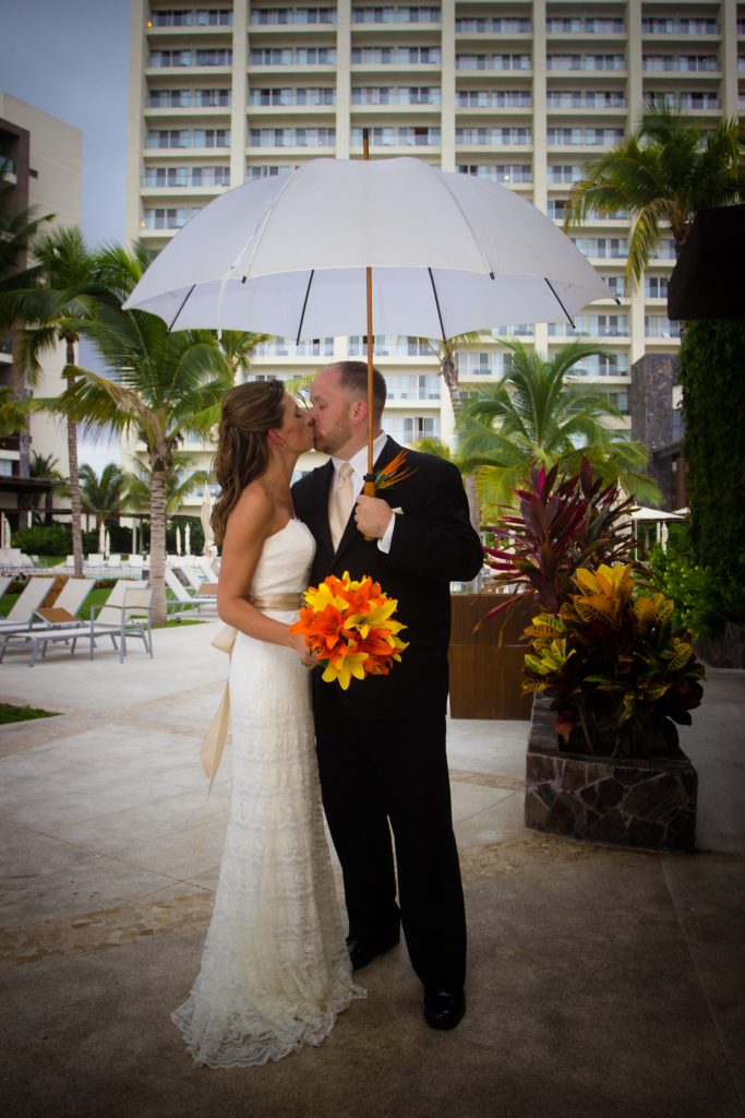Couple under umbrella here at Secrets Vallarta
