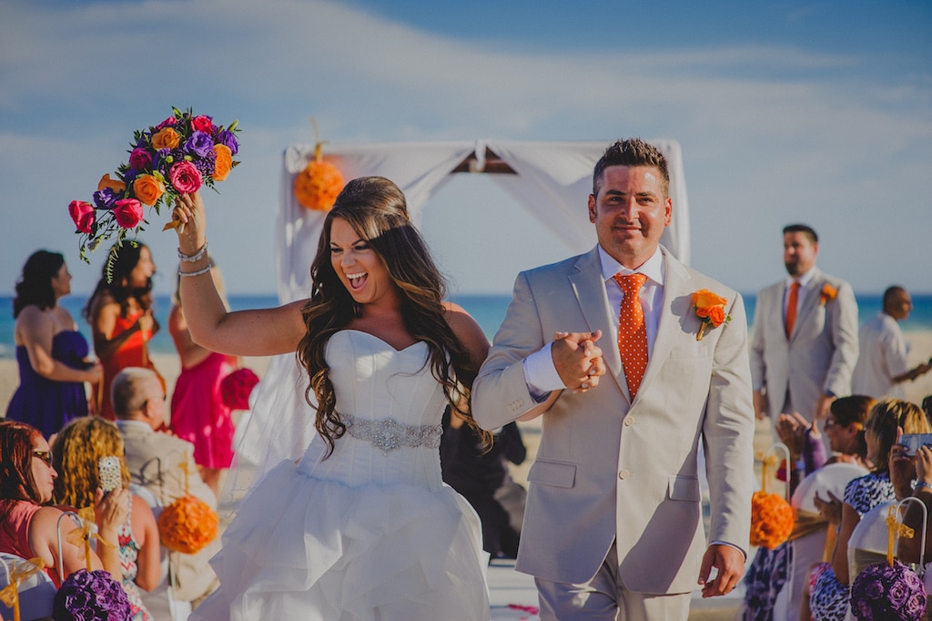 Couple leaving their ceremony in Los cabos 