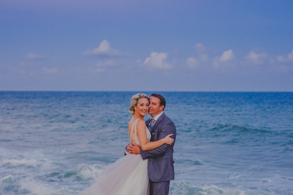 Los Cabos wedding couple on the beach with blue backdrop of ocean