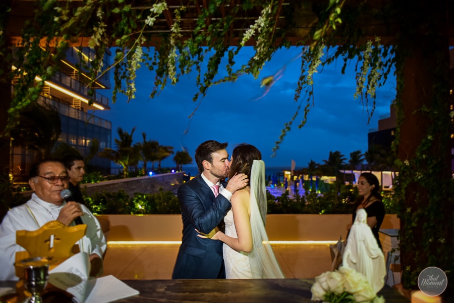  Couple sharing a kiss at their wedding reception 