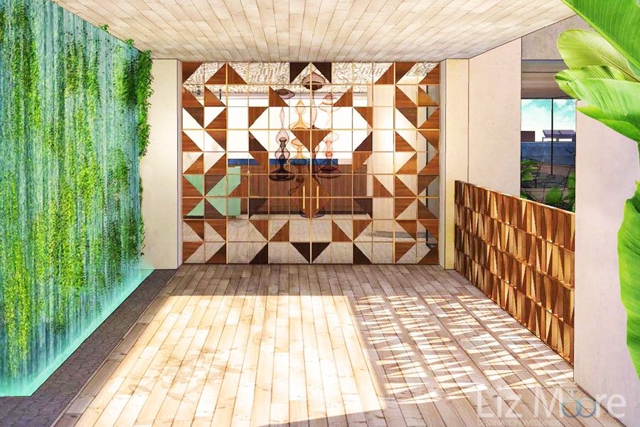 Lobby area with artful decorated tiles and green artwork display and light hardwood floors