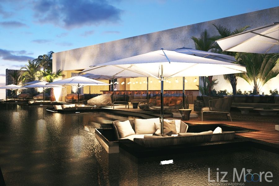 outdoor lounge area at night With beautiful soft lighting and white umbrella's