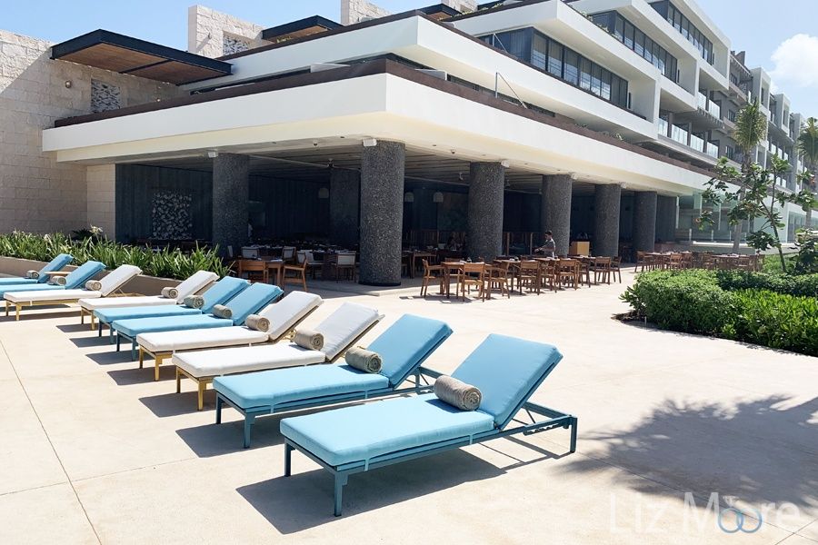 Resort lounge chairs  located side by side Close to the main restaurant