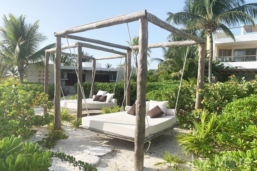 beach cabanas Made for two people with  wooden Beams and sand surrounding them