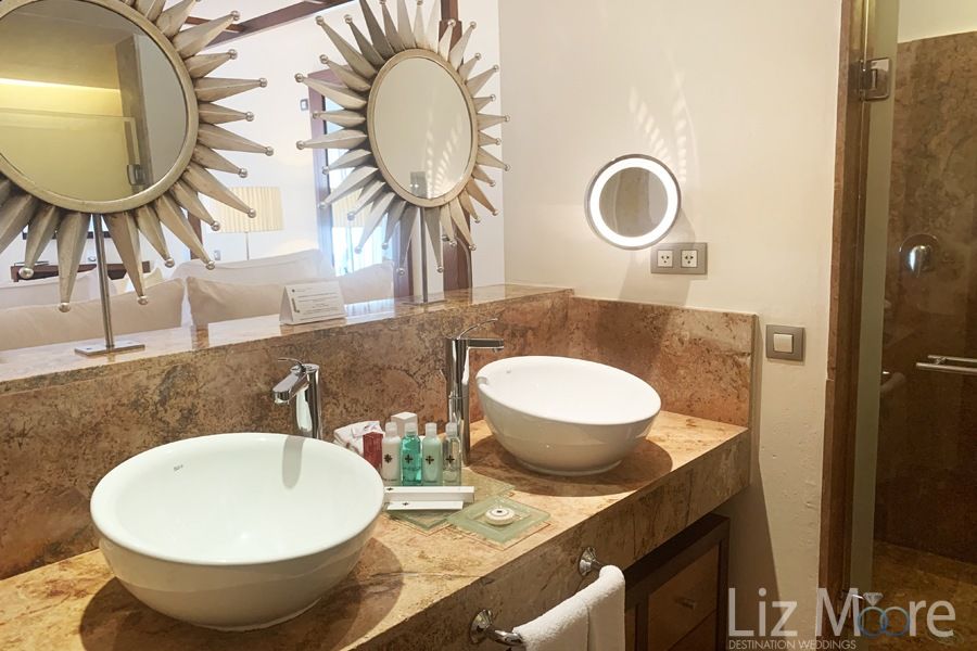 bedroom bathroom With two double Vanity sinks And sunflower mirrors