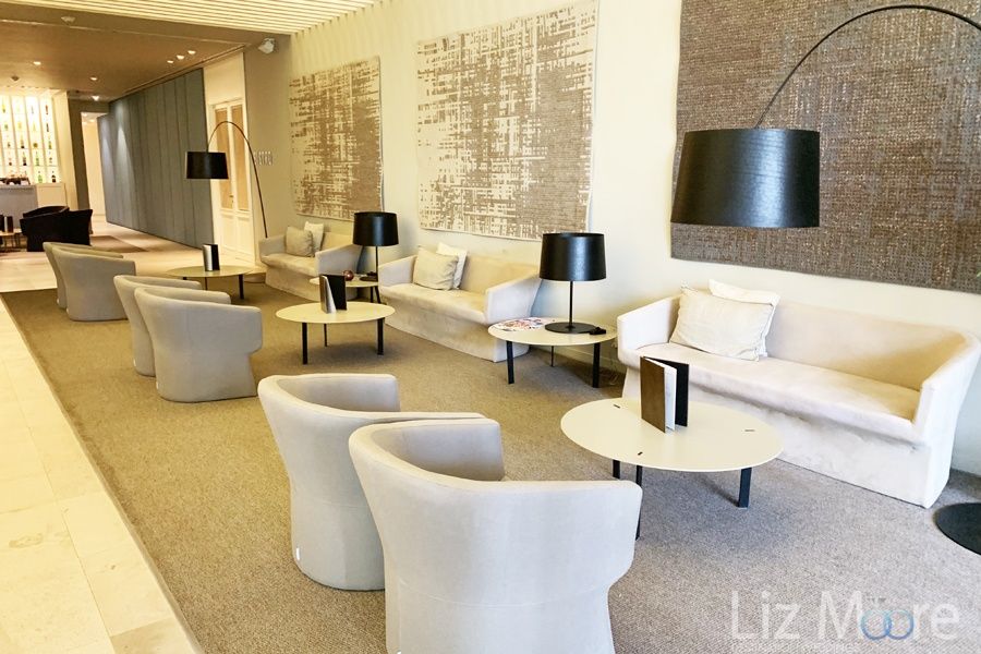 Main lobby area with a beautiful comfortable white couches and chairs and tables