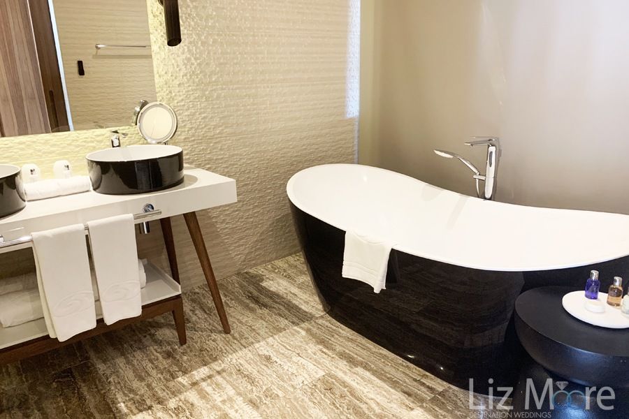 Standard bathroom with soaker tub Beautiful flooring and white decor in bathroom