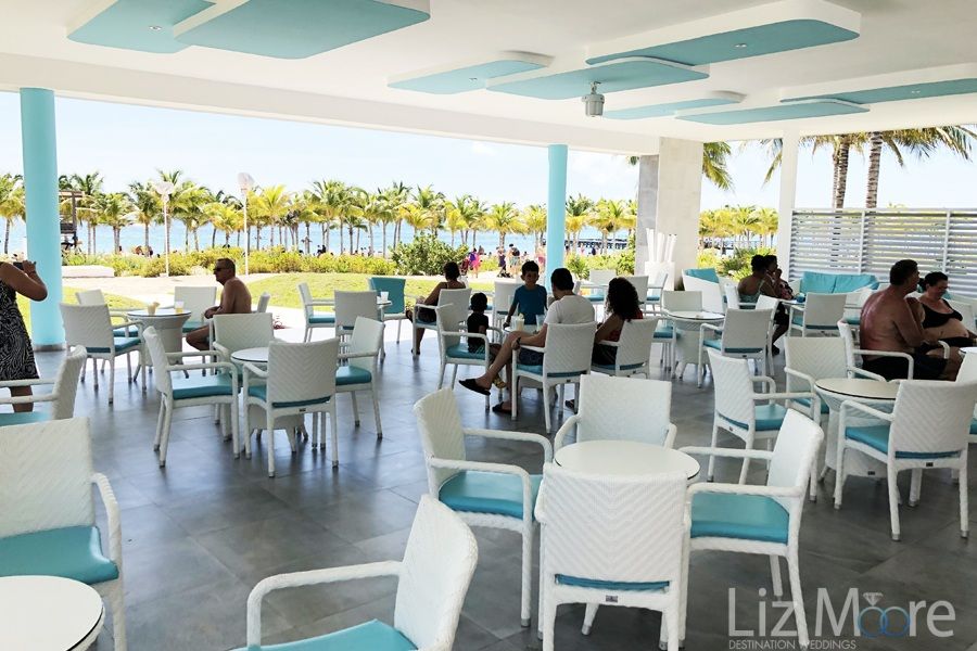 restaurant with outdoor seating covered ceiling and review of the ocean
