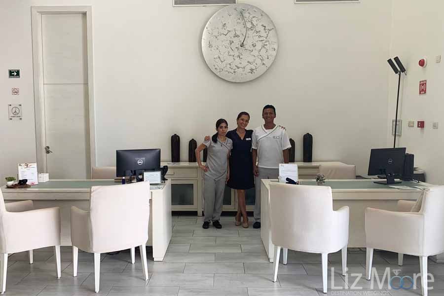Main reception staff surrounded by white chairs and a table and a beautiful our Decor clock