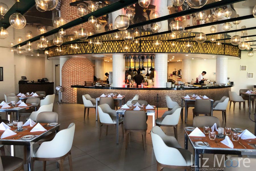 Italian Restaurant With beautiful chandelier bubble lighting and white Comfy chairs