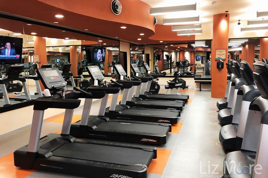 Main fitness center with the treadmills and weightsAnd water machines and TV stations