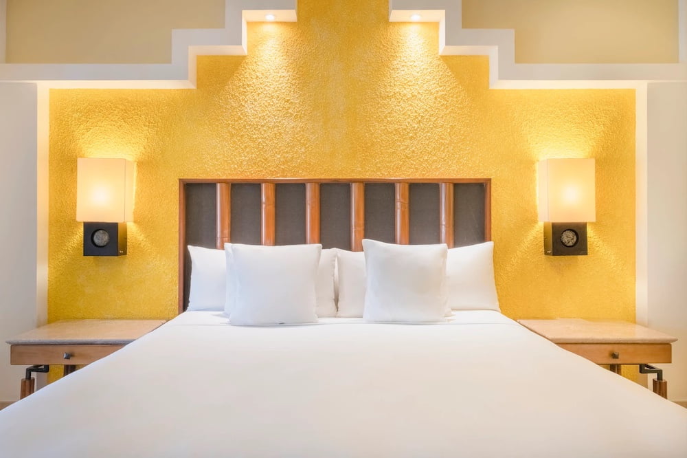 Selection Paraiso Maya Suites bedroom with beautiful yellow headboard