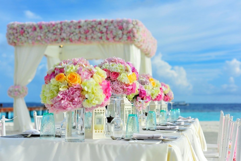 Bouquets of flowers at reception on the beach