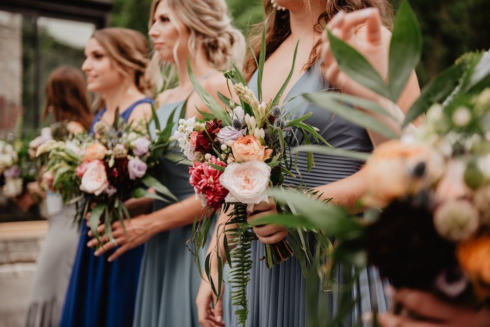 Bridesmaids at wedding with flower bouquets