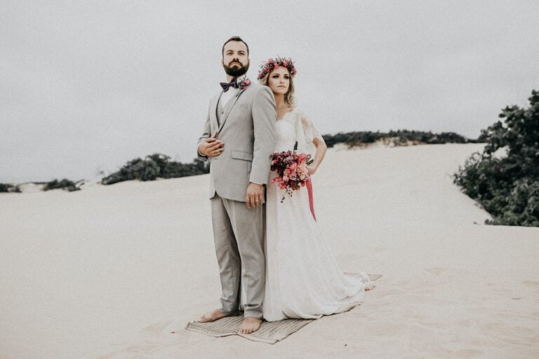 Wedding couple on beach with sand in background