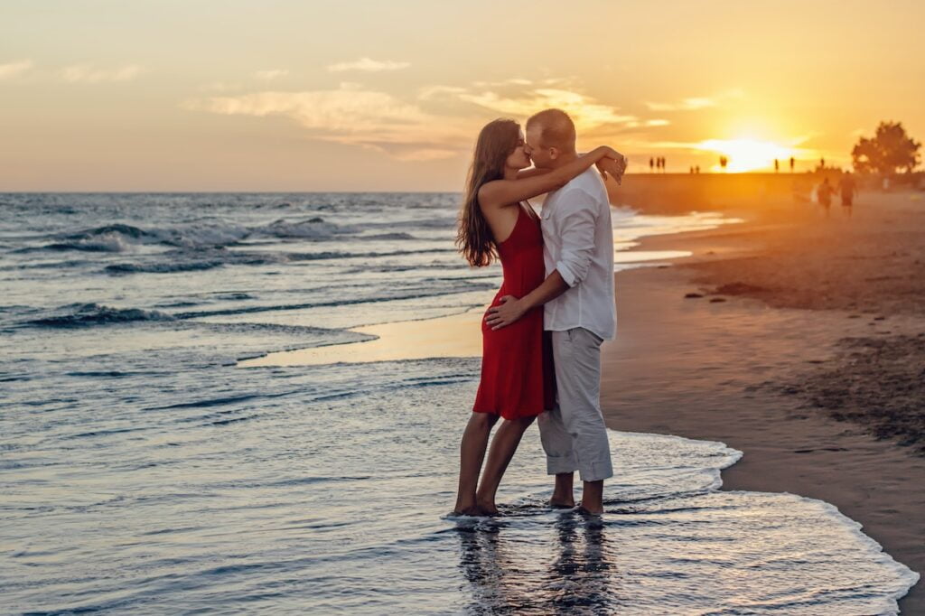 Couple kissing on beach evening sunset caribbean