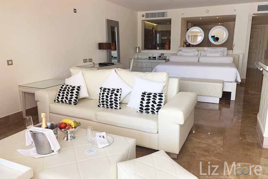 The-Beloved-Hotel-Playa-Mujeres-bedroom-and-couch-area-qbn066rchh7a085j2hceiuc0adgjl3u79nmr56uo74